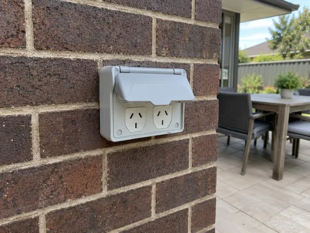 Outdoor double power point on a brick exterior wall beside a patio in Belmont